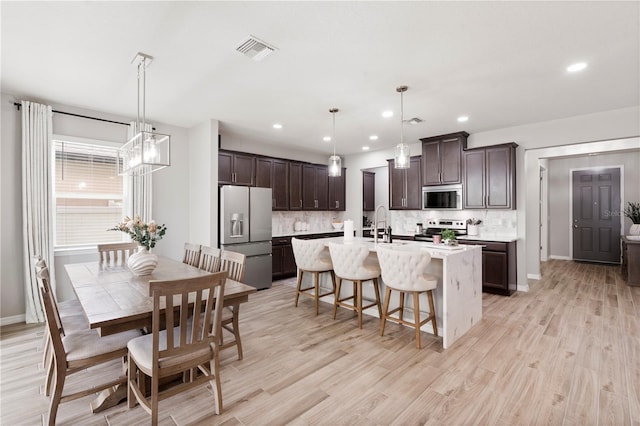 11719 Tetrafin Dr, Riverview, FL 33579 - kitchen featuring appliances with stainless steel finishes, dark brown cabinets, backsplash, and recessed lighting