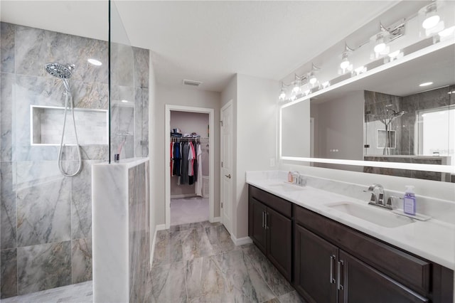 11719 Tetrafin Dr, Riverview, FL 33579 - bathroom featuring a marble finish shower, double vanity, marble finish floors, baseboards, and a walk in closet