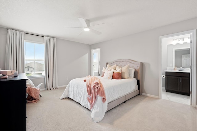 11719 Tetrafin Dr, Riverview, FL 33579 - bedroom featuring light carpet, baseboards, connected bathroom, and a ceiling fan