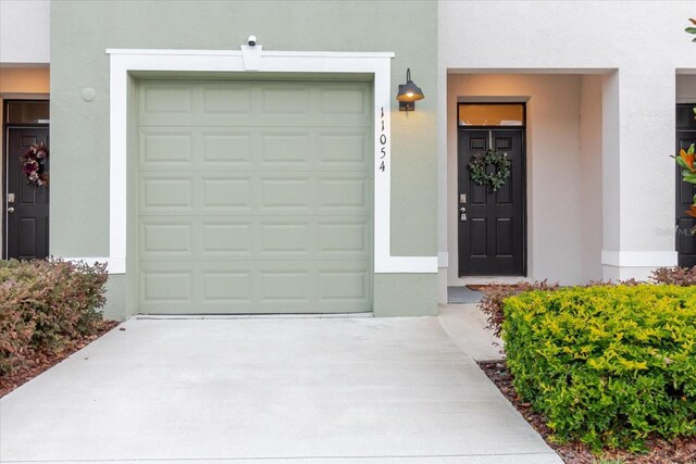 11054 Crescent Deer Dr, Land O Lakes, FL 34638 - entrance to property with driveway, stucco siding, and a garage
