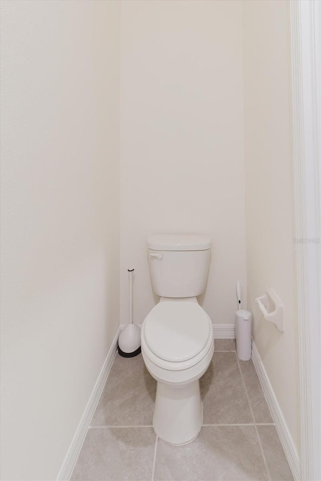 11054 Crescent Deer Dr, Land O Lakes, FL 34638 - bathroom with toilet, tile patterned floors, and baseboards