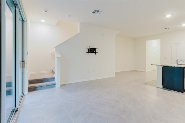 11054 Crescent Deer Dr, Land O Lakes, FL 34638 - spare room featuring stairway, recessed lighting, a sink, a smoke detector, and light tile patterned floors