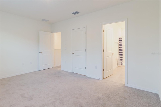 11054 Crescent Deer Dr, Land O Lakes, FL 34638 - unfurnished bedroom with light colored carpet, connected bathroom, and baseboards