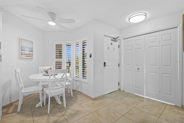 5445 Gulf Blvd Unit 210, St Pete Beach, FL 33706 - dining space with ceiling fan, light tile patterned floors, and baseboards