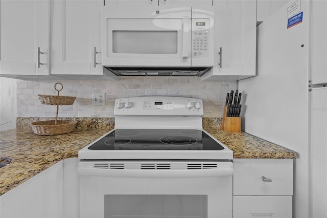 5445 Gulf Blvd Unit 210, St Pete Beach, FL 33706 - kitchen with white appliances, white cabinets, tasteful backsplash, and light stone countertops