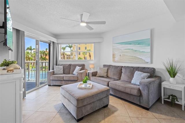 5445 Gulf Blvd Unit 210, St Pete Beach, FL 33706 - living area featuring ceiling fan, light tile patterned flooring, and a textured ceiling