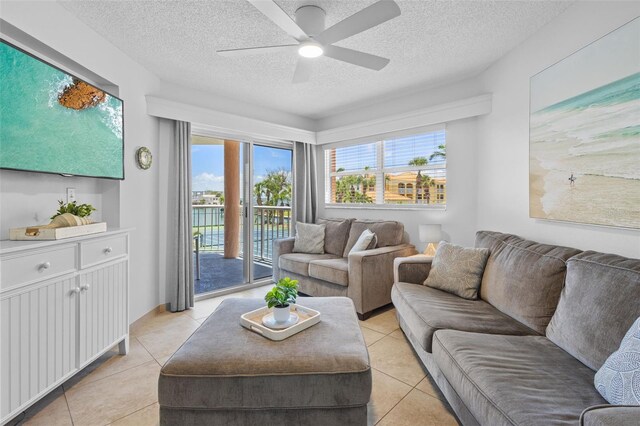 5445 Gulf Blvd Unit 210, St Pete Beach, FL 33706 - living room with light tile patterned floors, a textured ceiling, and ceiling fan