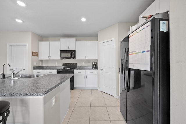 4403 Eternal Prince, Sun City Center, FL 33573 - kitchen with black appliances, a sink, white cabinets, light tile patterned floors, and recessed lighting