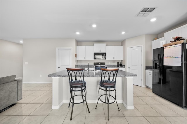 4403 Eternal Prince, Sun City Center, FL 33573 - kitchen featuring black appliances, white cabinets, light tile patterned floors, a kitchen bar, and recessed lighting