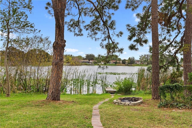 12529 Mondragon Dr, Tampa, FL 33625 - view of grassy yard featuring an outdoor fire pit and a water view