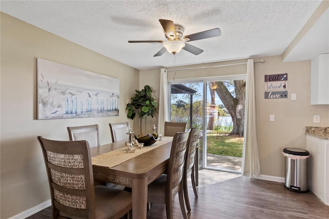 12529 Mondragon Dr, Tampa, FL 33625 - dining area with wood finished floors, a textured ceiling, baseboards, and ceiling fan