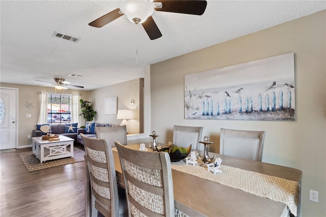 12529 Mondragon Dr, Tampa, FL 33625 - dining room with a ceiling fan, wood finished floors, a textured ceiling, and baseboards