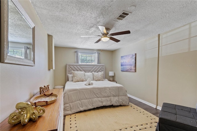 12529 Mondragon Dr, Tampa, FL 33625 - bedroom with wood finished floors, a textured ceiling, ceiling fan, and baseboards