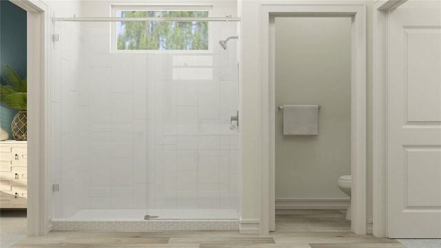 7546 E 117th Ln, Palmetto, FL 34221 - full bathroom featuring a stall shower, toilet, wood finished floors, and baseboards