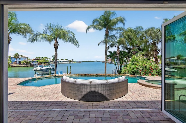 511 Island Way, Clearwater Beach, FL 33767 - view of pool featuring a water view, a pool with connected hot tub, and a patio area