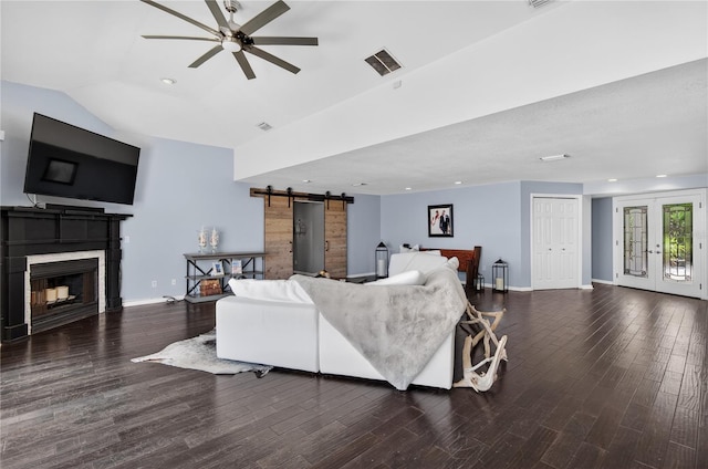 511 Island Way, Clearwater Beach, FL 33767 - living area featuring a barn door, ceiling fan, wood finished floors, a fireplace, and lofted ceiling