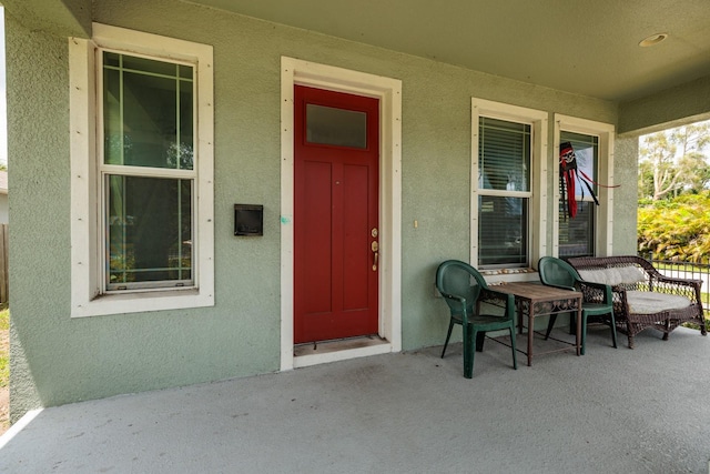 4301 5th Ave N, Saint Petersburg, FL 33713 - doorway to property featuring covered porch and stucco siding