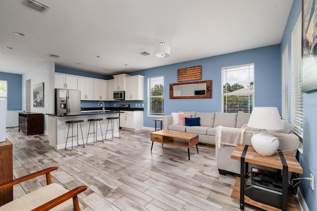 4301 5th Ave N, Saint Petersburg, FL 33713 - living room featuring healthy amount of natural light, baseboards, light wood-type flooring, and recessed lighting