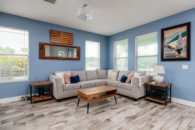 4301 5th Ave N, Saint Petersburg, FL 33713 - living area featuring wood tiled floors, healthy amount of natural light, and baseboards