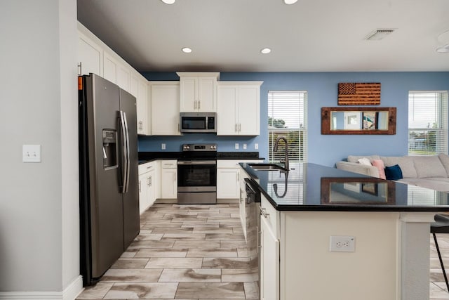 4301 5th Ave N, Saint Petersburg, FL 33713 - kitchen featuring stainless steel appliances, a sink, healthy amount of natural light, a kitchen breakfast bar, and recessed lighting
