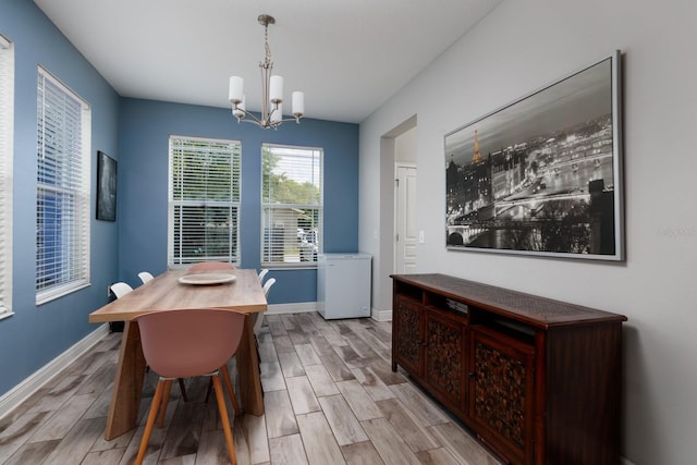 4301 5th Ave N, Saint Petersburg, FL 33713 - dining room with a chandelier, light wood-type flooring, and baseboards