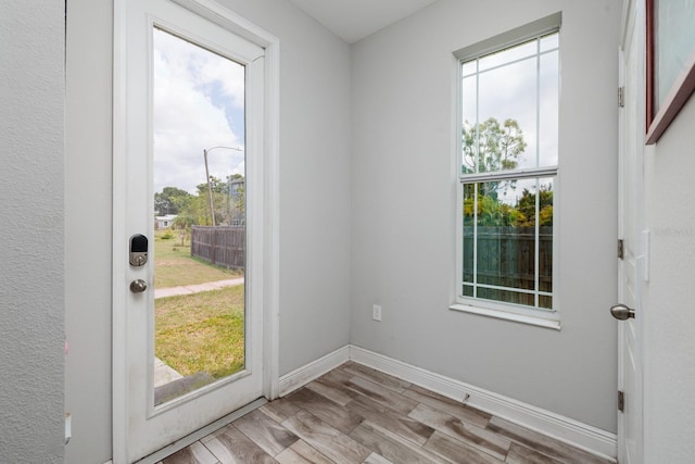 4301 5th Ave N, Saint Petersburg, FL 33713 - doorway to outside featuring plenty of natural light, wood finished floors, and baseboards