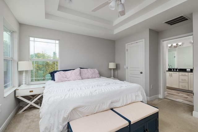 4301 5th Ave N, Saint Petersburg, FL 33713 - bedroom with light carpet, baseboards, connected bathroom, and a sink