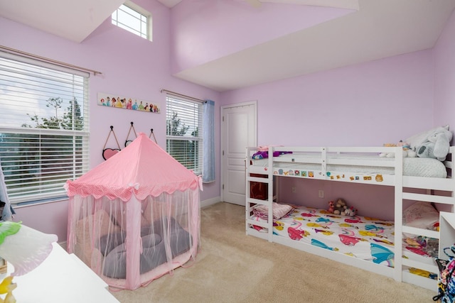 4301 5th Ave N, Saint Petersburg, FL 33713 - bedroom with carpet floors, multiple windows, a towering ceiling, and baseboards