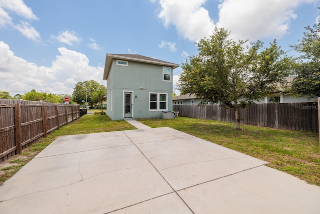 4301 5th Ave N, Saint Petersburg, FL 33713 - back of property with stucco siding and a patio