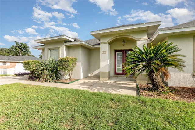629 Orange Valley Ln, Lakeland, FL 33813 - view of front of house featuring stucco siding, a front yard, and roof with shingles
