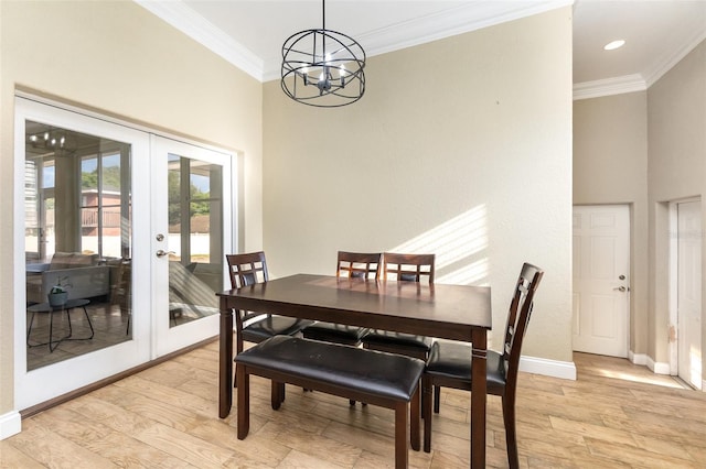 629 Orange Valley Ln, Lakeland, FL 33813 - dining area with ornamental molding, french doors, a chandelier, baseboards, and light wood-style floors