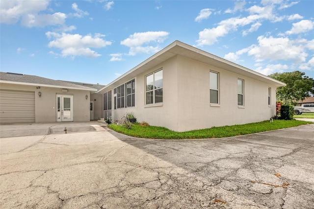 629 Orange Valley Ln, Lakeland, FL 33813 - rear view of house with stucco siding and driveway