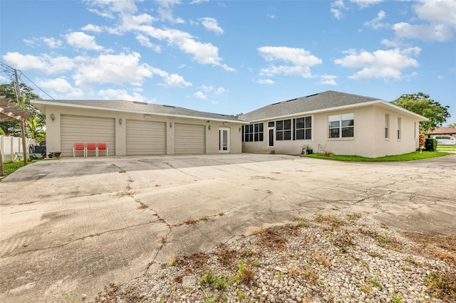 629 Orange Valley Ln, Lakeland, FL 33813 - rear view of property with stucco siding and a garage