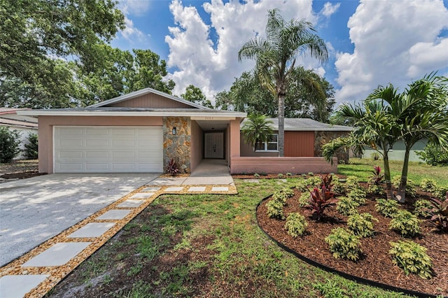 2063 Ridgecrest Dr, Dunedin, FL 34698 - view of front facade with concrete driveway, a garage, and stone siding