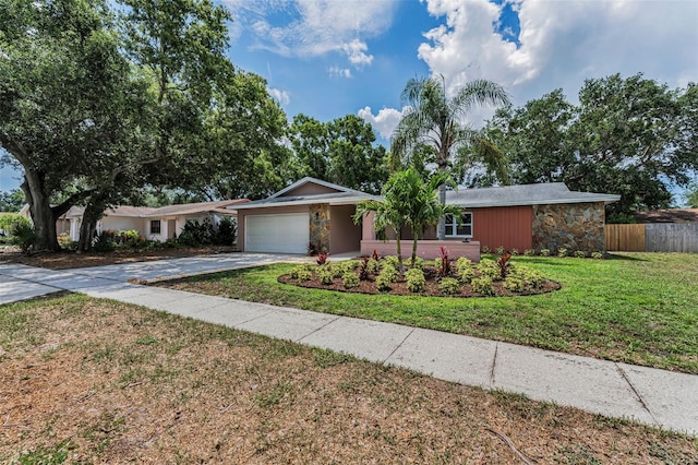 2063 Ridgecrest Dr, Dunedin, FL 34698 - ranch-style home featuring stone siding, an attached garage, and driveway