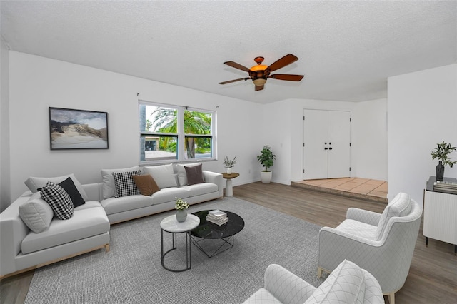 2063 Ridgecrest Dr, Dunedin, FL 34698 - living room featuring wood finished floors, radiator heating unit, ceiling fan, and a textured ceiling