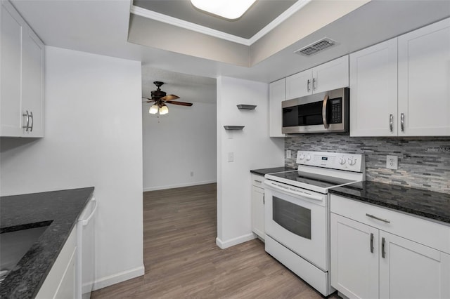 2063 Ridgecrest Dr, Dunedin, FL 34698 - kitchen featuring white appliances, ceiling fan, backsplash, baseboards, and white cabinets
