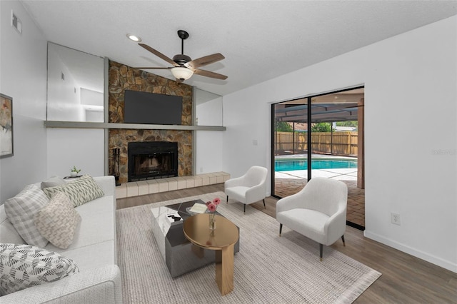 2063 Ridgecrest Dr, Dunedin, FL 34698 - living area with a ceiling fan, wood finished floors, baseboards, a fireplace, and recessed lighting