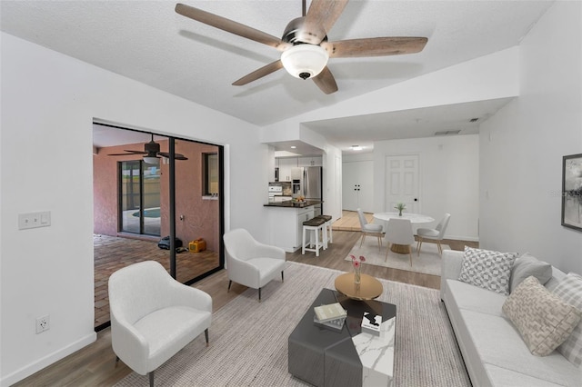 2063 Ridgecrest Dr, Dunedin, FL 34698 - living area with wood finished floors, a ceiling fan, and baseboards