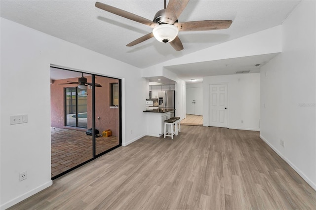2063 Ridgecrest Dr, Dunedin, FL 34698 - unfurnished living room featuring ceiling fan, light wood-type flooring, and baseboards