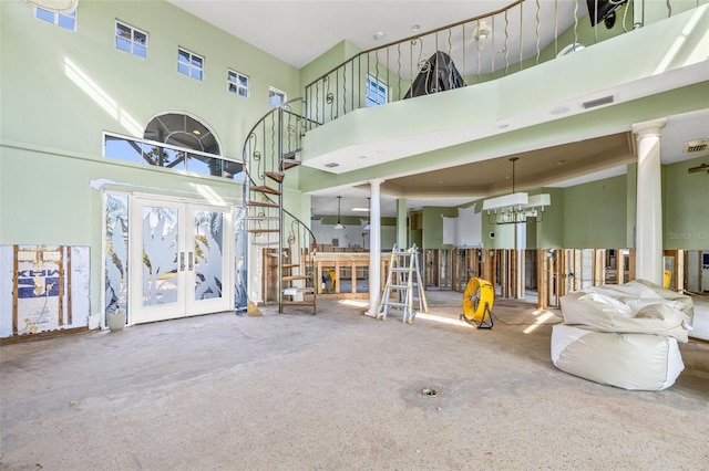17077 Dolphin Dr, North Redington Beach, FL 33708 - misc room with a towering ceiling, french doors, a chandelier, stairs, and decorative columns