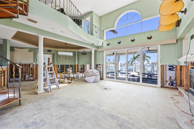 17077 Dolphin Dr, North Redington Beach, FL 33708 - living area with decorative columns, healthy amount of natural light, a towering ceiling, and a ceiling fan