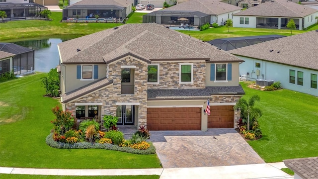 9136 Warm Springs Cir, Parrish, FL 34219 - view of front of house with stone siding, an attached garage, stucco siding, and decorative driveway