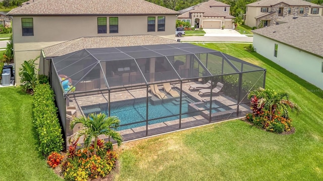 9136 Warm Springs Cir, Parrish, FL 34219 - view of pool featuring a yard, a patio area, a residential view, a pool with connected hot tub, and glass enclosure