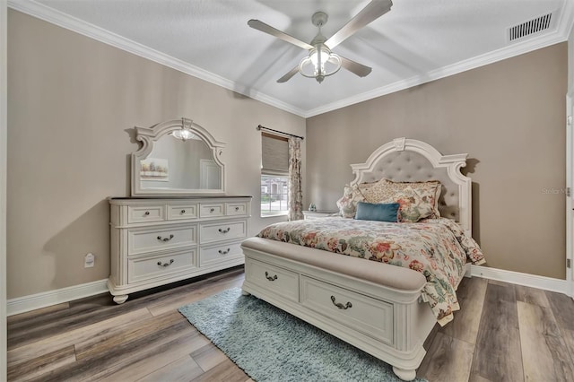 9136 Warm Springs Cir, Parrish, FL 34219 - bedroom with wood finished floors, ornamental molding, baseboards, and a ceiling fan