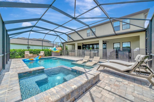 9136 Warm Springs Cir, Parrish, FL 34219 - view of swimming pool with a ceiling fan, a patio area, a pool with connected hot tub, and glass enclosure