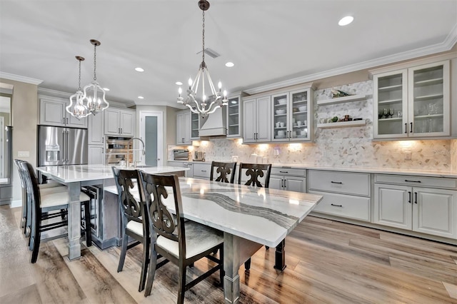 9136 Warm Springs Cir, Parrish, FL 34219 - dining space featuring a chandelier, ornamental molding, light wood finished floors, and recessed lighting