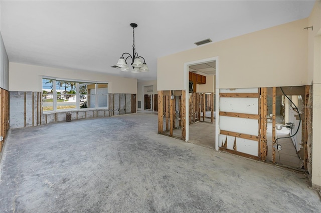 11465 7th St E, Treasure Island, FL 33706 - unfurnished living room featuring a chandelier