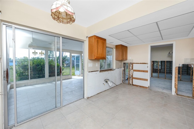 11465 7th St E, Treasure Island, FL 33706 - kitchen with brown cabinetry and light tile patterned floors