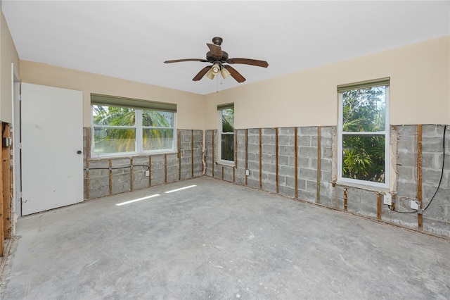 11465 7th St E, Treasure Island, FL 33706 - unfurnished room featuring ceiling fan and unfinished concrete flooring